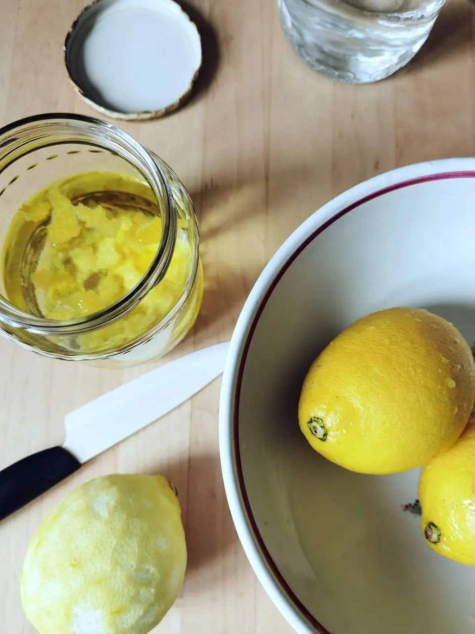 Fresh lemons and a jar of lemon preserve