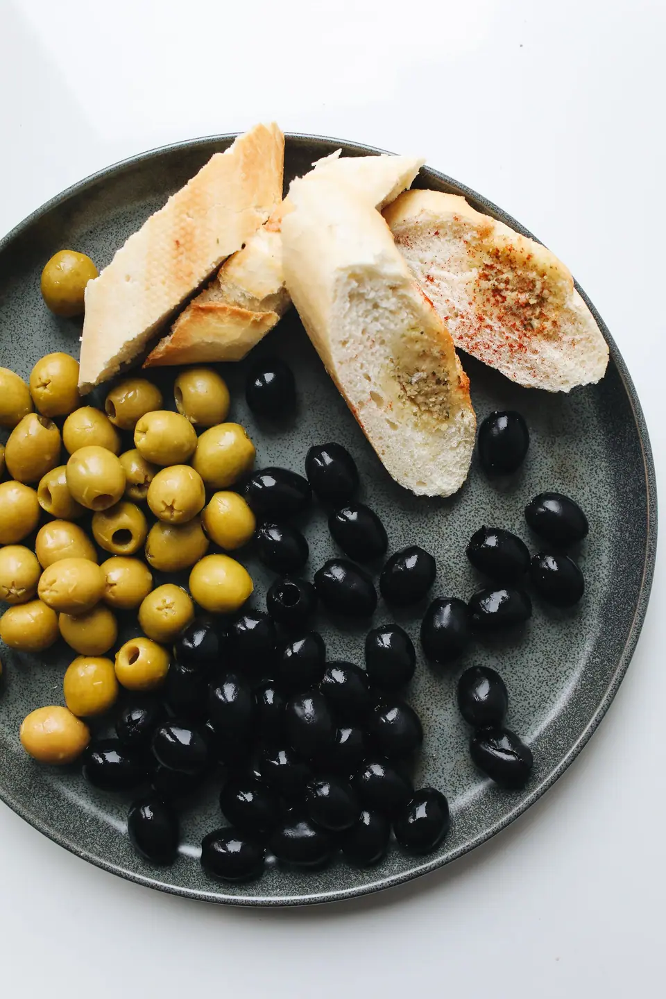 Green and black olives served with bread